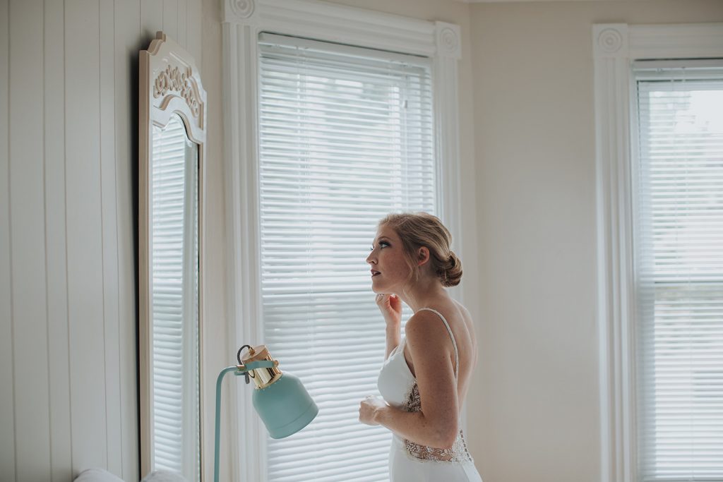 bride gets ready at an airbnb in kingston ny on her wedding day